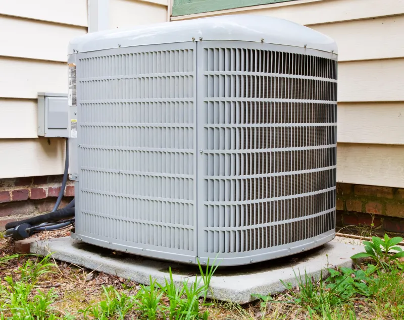 NATE-certified HVAC technician diagnosing and performing AC repair on an outdoor condenser unit at a home in Hernando Beach, Florida