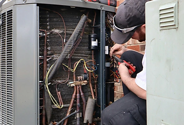 ac repair air conditioning service reduced NATE-certified technician performing emergency AC repair on an outdoor condenser unit at a Florida home during a service call