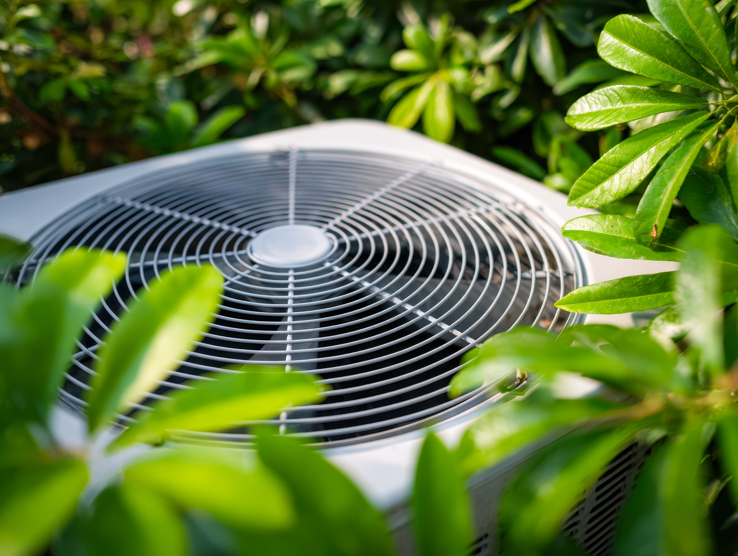 NATE-certified HVAC technician working on an air conditioning unit in a Spring Hill residence