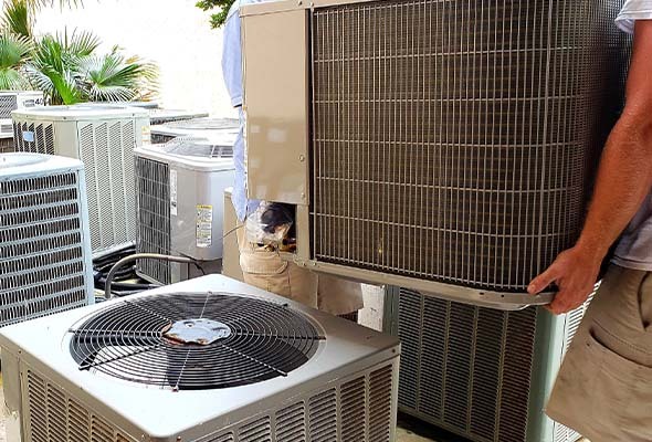 air conditioning installation service and ac replacement service Professional HVAC technicians installing a new high-efficiency central air conditioning system in a Tampa Bay area home