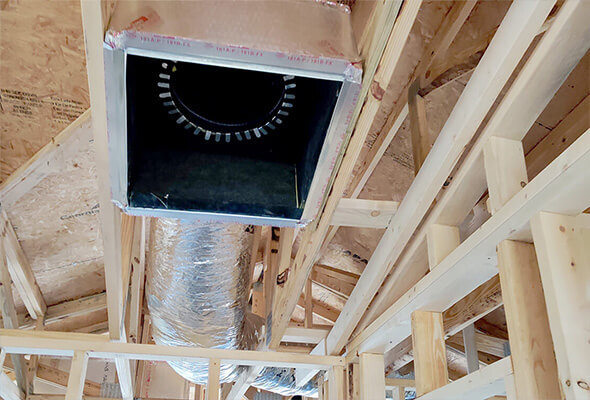 ductwork services HVAC technician inspecting and sealing ductwork in a Florida home attic to improve airflow and AC efficiency