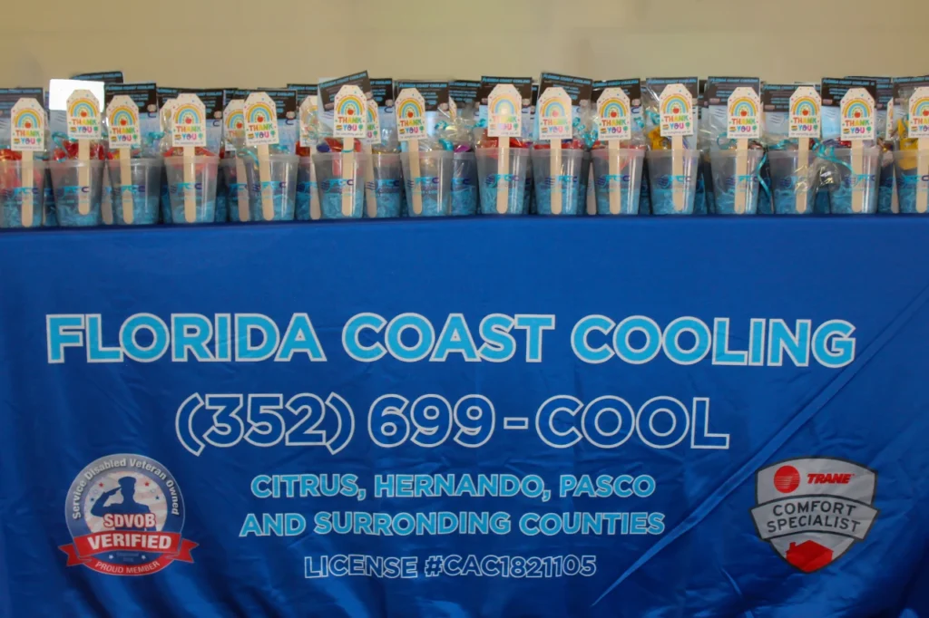 IMG_20260722_150317-reduced Rows of Florida Coast Cooling Teacher Appreciation gift cups on the company banner at Winding Waters K-8 in Hernando County